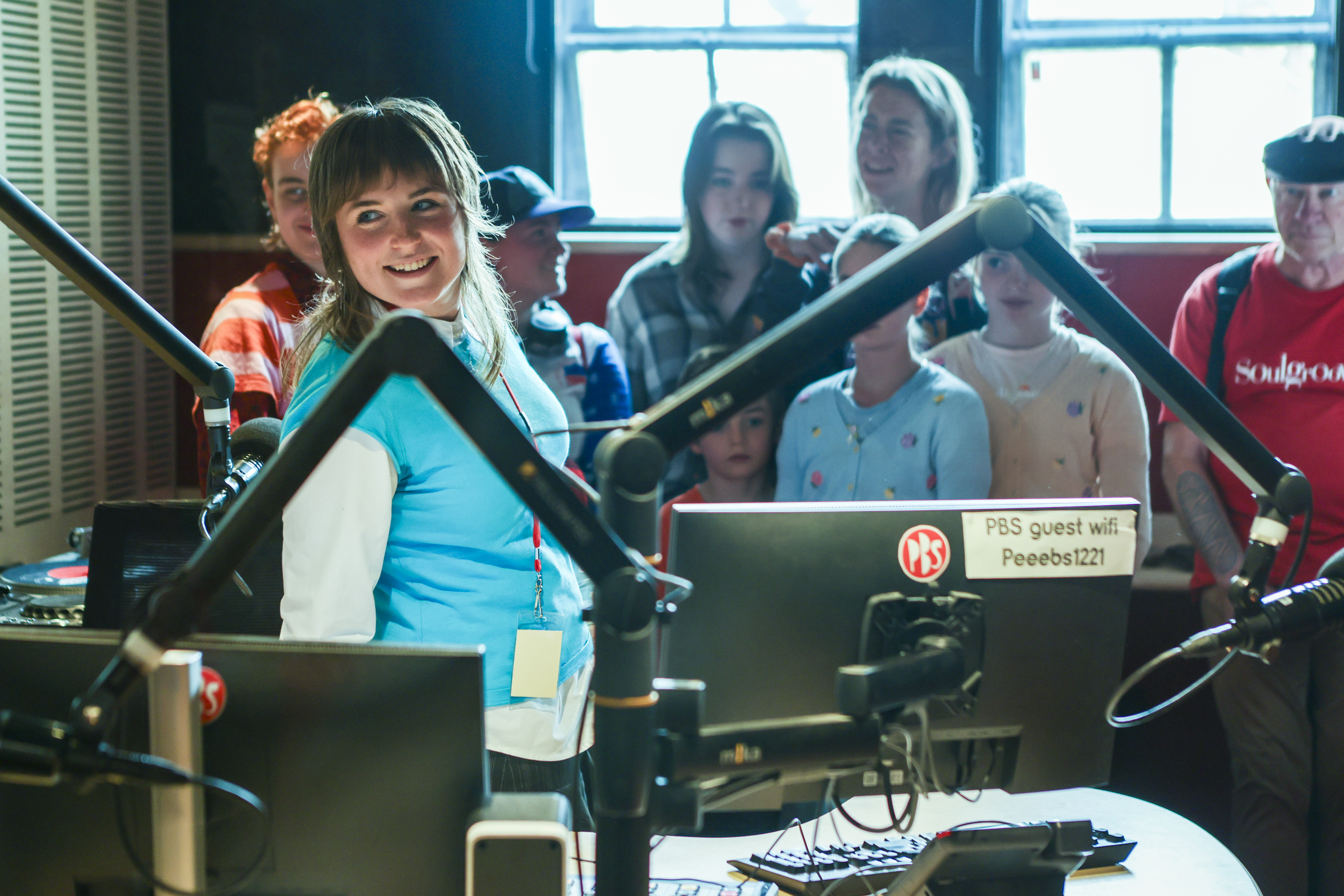 PBS announcer Ponie Curtis in studio 1 shows people around